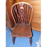 An antique Elm seated wheelback Side Chair