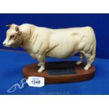 A Beswick figure of a 'Charolais Bull' on wooden plinth, matt finished, 9" long x 6" tall.