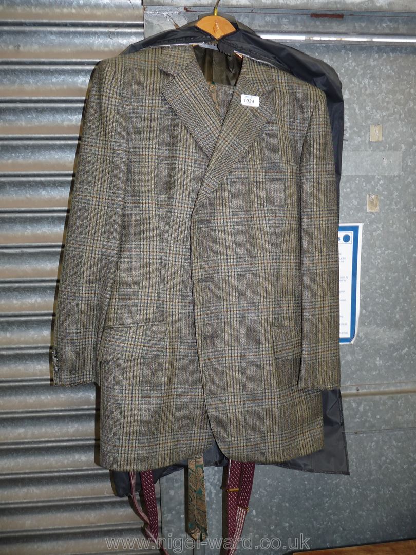 A gents tweed made to measure suit consisting of a button up jacket and trousers with braces,