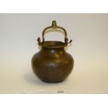 An early Bronze church water bucket, of cauldron form with a swing handle,