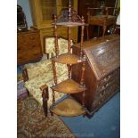 A mixed woods four stage Corner What-not having turned supports and inlaid urn and swag details,