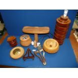 A quantity of treen including a lamp stand, pot pourri pots, wooden picture holders etc.