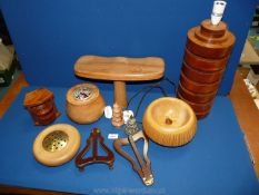 A quantity of treen including a lamp stand, pot pourri pots, wooden picture holders etc.