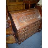 A profusely carved Oak Bureau probably mid-late 19th c.