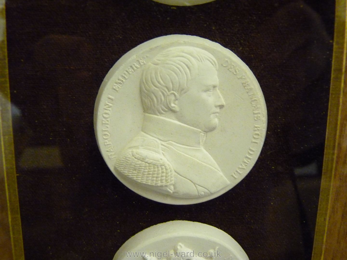 A framed small group of classical plaster cast medallions. - Image 4 of 7