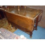 A large and unusual heavy Oak dropleaf swing leg Dining Table standing on fluted legs,