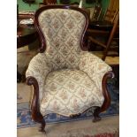 A Victorian button back Mahogany show frame Armchair having scroll feet and arms, cream ground,