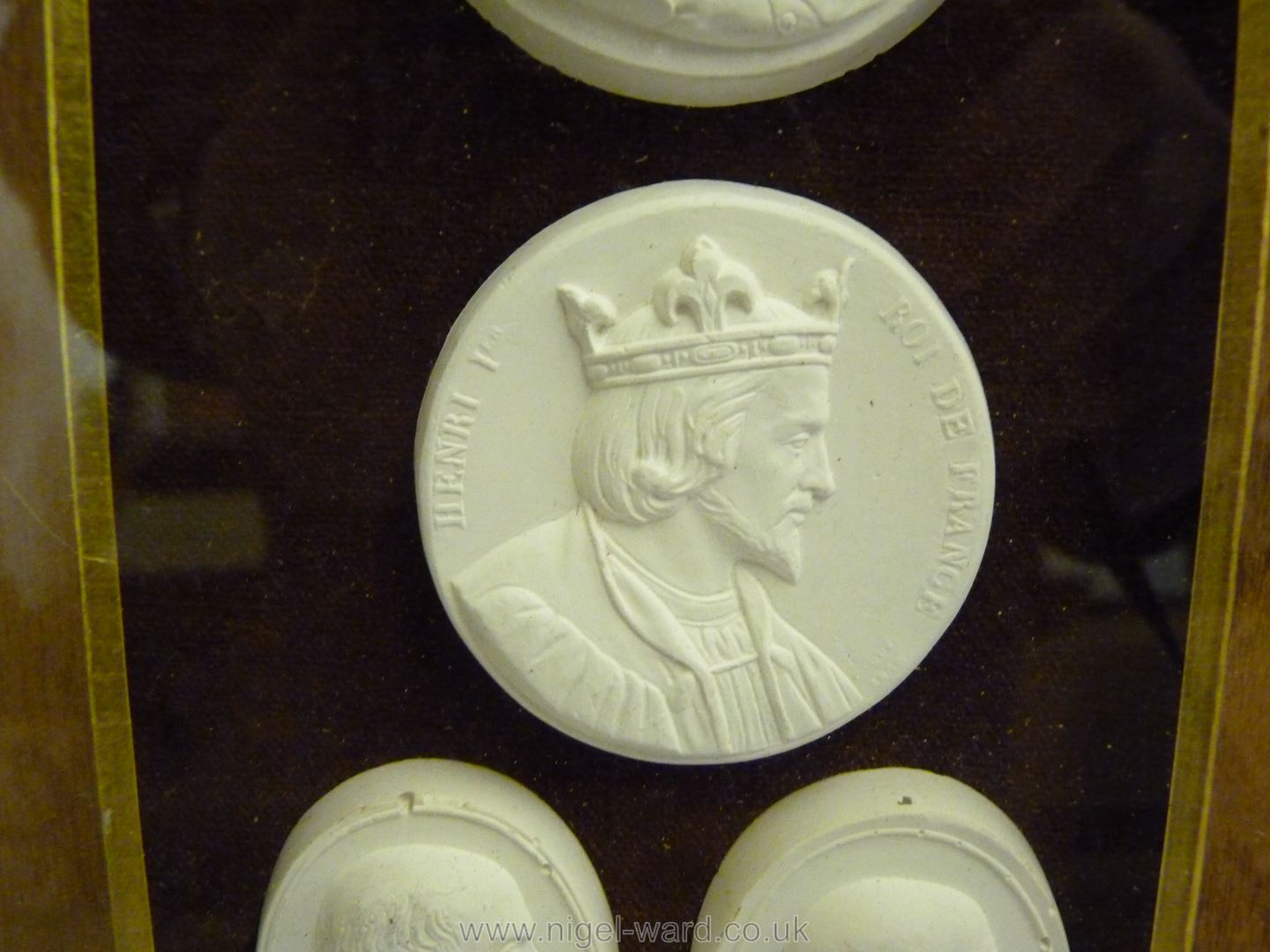 A framed small group of classical plaster cast medallions. - Image 5 of 7