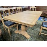 A contemporary light Oak pull-out extending Dining Table,