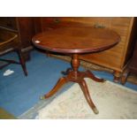 A contemporary circular Mahogany occasional Table having a cross-banded top and standing on a