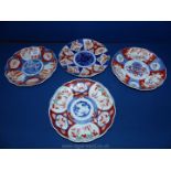 Four oriental Plates, with blue and amber floral decoration,