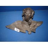 A cast Inkwell in the shape of a Spaniel holding a duck forming the pen rest,