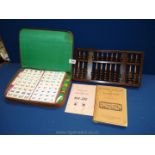 A cased Mah Jong set, Chinese abacus and instruction book.