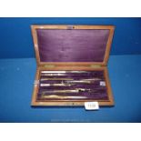 A Mahogany cased incomplete set of drawing instruments but with drawing implements and stencils in