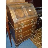 An Oak and burr wood finish Bureau,