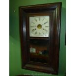 A veneered cased American Wall Clock, the cream coloured painted face having Roman numerals,