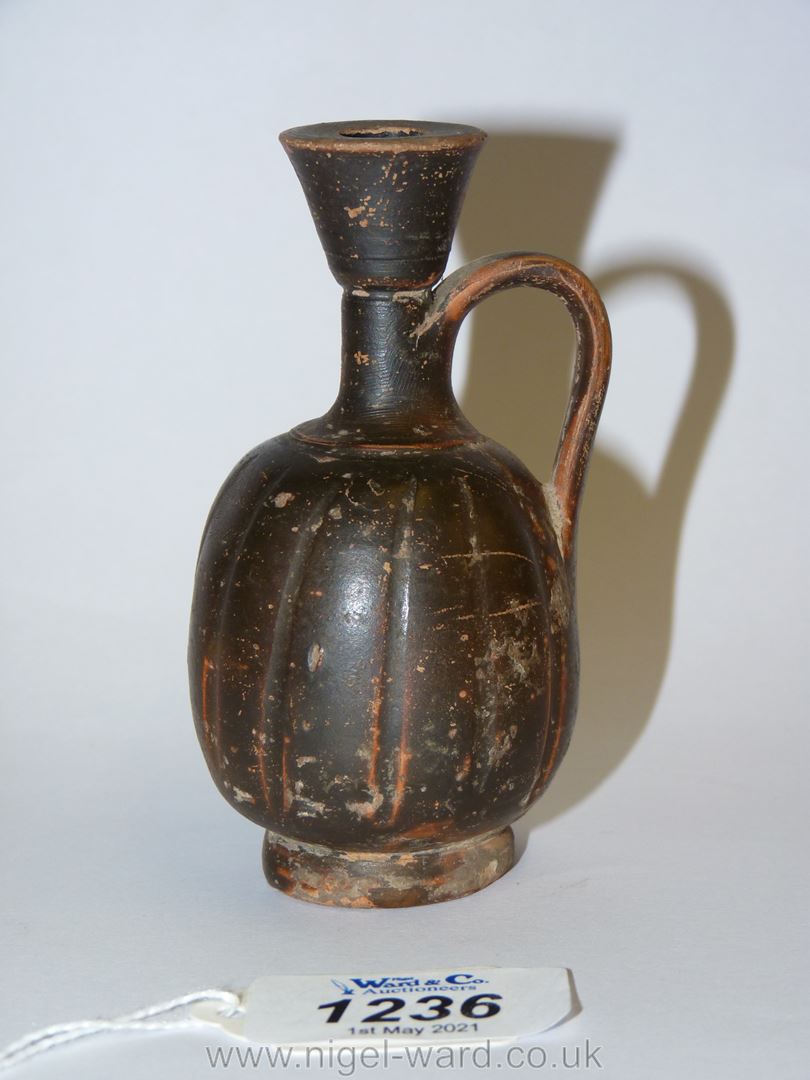An ancient monochrome glaze small lekythos, of shallow fluted form - South Italian Greek,
