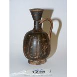 An ancient monochrome glaze small lekythos, of shallow fluted form - South Italian Greek,