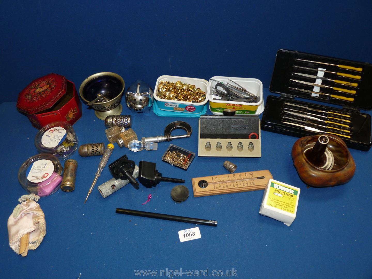 A box of miscellanea to include tweezers and pins, thermometer, pen stand,