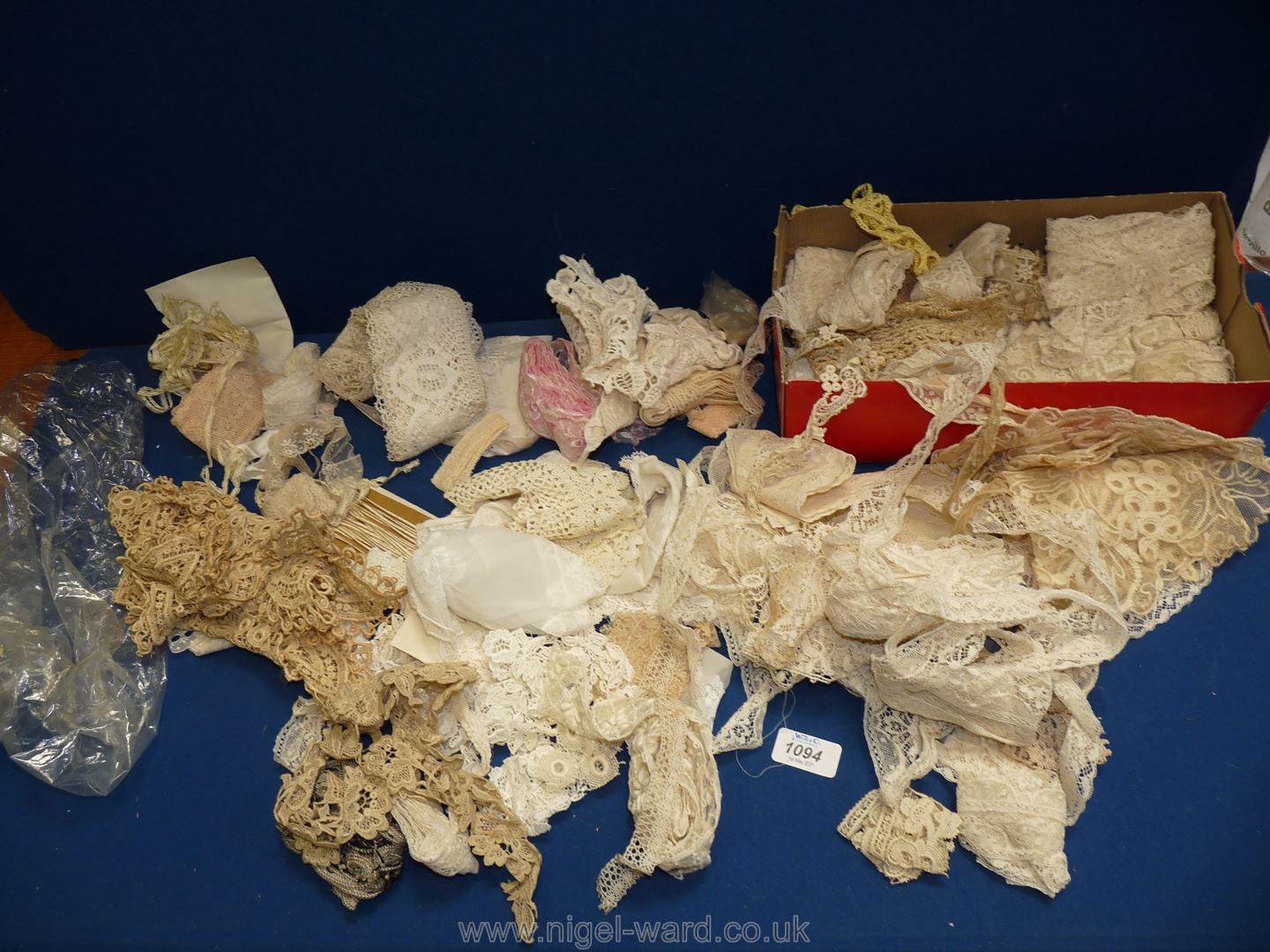 A box of vintage lace trimmings, crochet work and remnants.