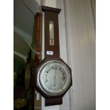 An Oak cased aneroid Barometer/Thermometer, the face with octagonal surround,