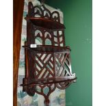 A Mahogany Gothic style fretwork hanging corner shelves, 38" tall (slightly cracked at bottom).