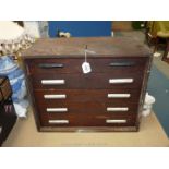 A carpenter's Cabinet having five drawers, with metal handles, 15" tall x 18 1/2" x 10".