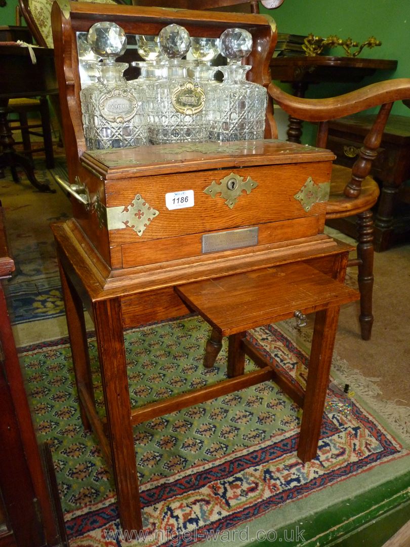 A good Oak three decanter Tantalus on a stand, mirror backed with brass fittings and carry handles. - Image 6 of 6