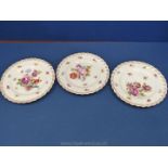 Three hand painted Plates, one marked 'Silesia', decorated with flowers with gilt detailing to rim,