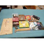 A box of miscellanea including mapping pens and vintage games.