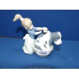 A small Lladro figure of a young girl washing a dog, no. S455, 5" long x 5" tall.