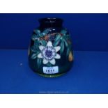 A Moorcroft Passion Flower vase, 6'' tall.
