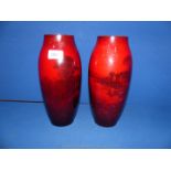 A pair of Royal Doulton Flambe glaze vases with cottage scene decoration, 11'' high,