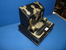A brass bound ebonised stationery Desk Stand with two brass topped green glass inkwells,