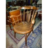 An elegant Welsh style solid circular seated Armchair standing on turned legs and H-stretcher,