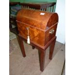 A most unusual domed top Walnut Workbox having pierced backplate drop handles and standing on an