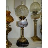 An oil lamp with black ceramic base, reeded pillar,