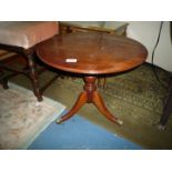 A Mahogany circular occasional Table having a cross-banded top and standing on a turned pillar with