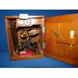 A fine quality Mahogany cased demountable brass Field Microscope with two eye piece lenses and one