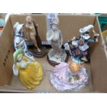 A quantity of porcelain and moulded figurines including young girl with cat,