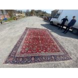 A large navy blue ground, with floral border, red ground central medallion, labelled made in Iran,