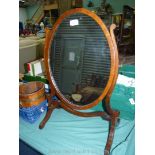 An elegant Mahogany framed oval vanity swing Mirror having a delicate stand,