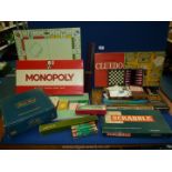 A box of games including Waddingtons Table Soccer, Cluedo, Trivial Pursuit, Scabble,