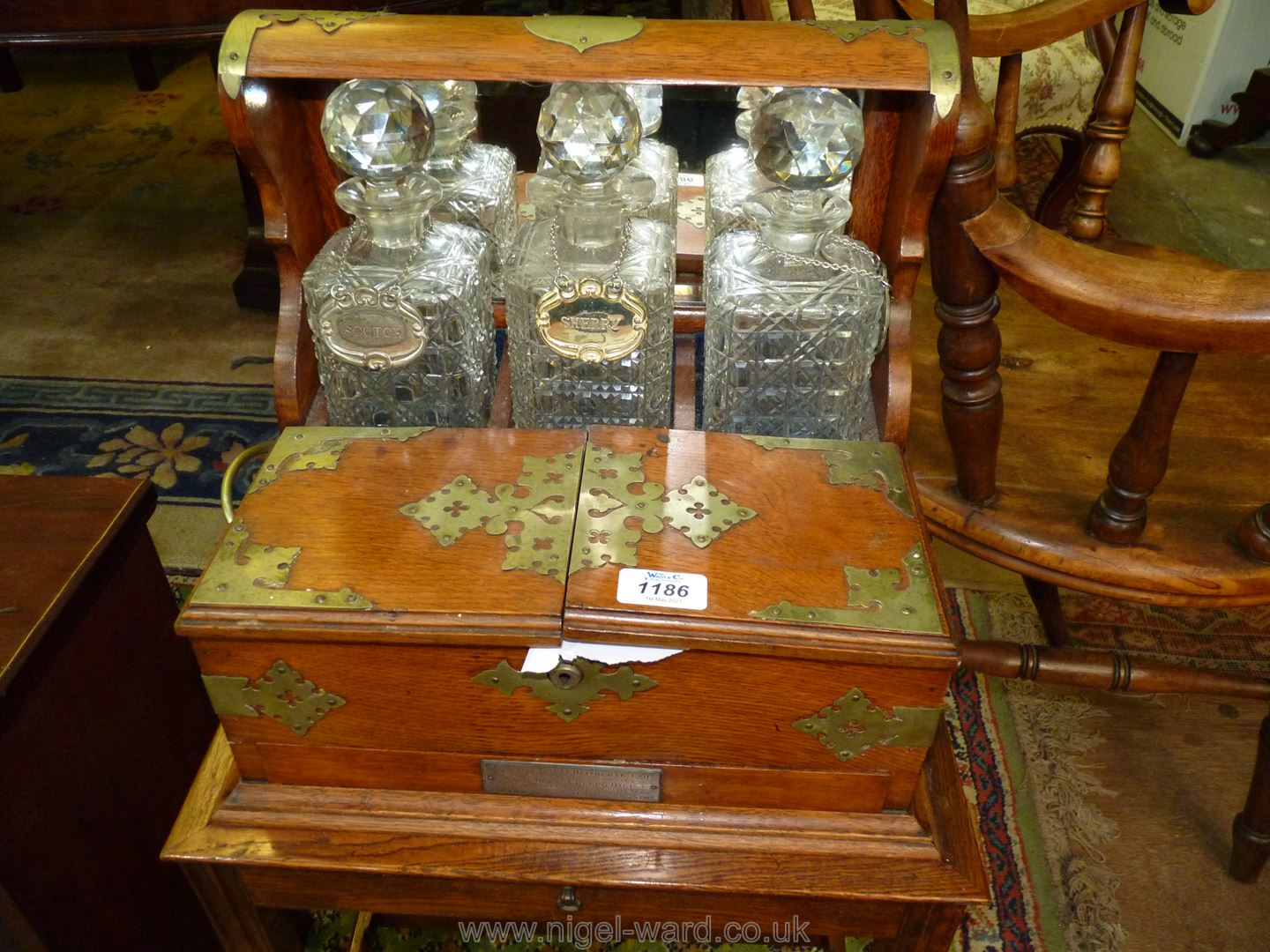 A good Oak three decanter Tantalus on a stand, mirror backed with brass fittings and carry handles. - Image 2 of 6