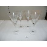 Four etched glass champagne/martini glasses.