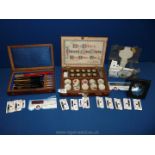 A Rosewood box with a set of seven miniature paint brushes,