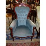 A reproduction darkwood show framed Button Back Armchair upholstered in blue Draylon type fabric