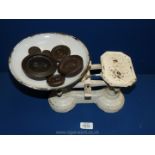 A white painted metal weighing Scales and six weights: 1 oz, 2 oz, 4 oz, 8 oz, 1lb, and 2 lb,