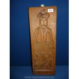 A naively carved wood wall panel,