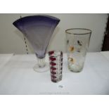 A large mauve studio glass vase with clear stem and base, an etched vase and one other.
